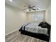 Bedroom featuring a bed, ceiling fan, and plantation shutters at 10618 Timber Stand St, Las Vegas, NV 89183