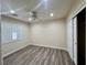 Bedroom featuring wood floors, a ceiling fan, and a closet at 10618 Timber Stand St, Las Vegas, NV 89183