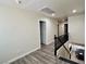 Hallway with wood floors and a black banister at 10618 Timber Stand St, Las Vegas, NV 89183