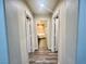 Hallway with wood floors, recessed lights, and view of bathroom at 10618 Timber Stand St, Las Vegas, NV 89183