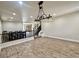 Spacious living room featuring wood-look floors, decorative lighting, and a view of the staircase and dining area at 10618 Timber Stand St, Las Vegas, NV 89183