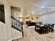 Open-concept living area featuring stairs and dining area at 10618 Timber Stand St, Las Vegas, NV 89183