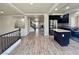 Open-concept space with wood-look floors, a staircase, and a view of the kitchen with a center island at 10618 Timber Stand St, Las Vegas, NV 89183