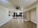 Open-concept living space with wood-look flooring, ceiling fan, and views of the kitchen and dining areas at 10618 Timber Stand St, Las Vegas, NV 89183
