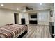 Spacious main bedroom featuring wood floors, recessed lights, ceiling fan, and plantation shutters at 10618 Timber Stand St, Las Vegas, NV 89183