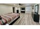 Spacious main bedroom featuring wood floors, recessed lights, ceiling fan, and plantation shutters at 10618 Timber Stand St, Las Vegas, NV 89183