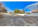 Spacious backyard surrounded by fencing and mature trees, offering ample room for activities at 1106 Emerald Stone Ave, North Las Vegas, NV 89081