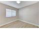 Neutral bedroom featuring wood-look flooring, base molding, a window, and recessed lighting at 1106 Emerald Stone Ave, North Las Vegas, NV 89081