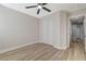 Bedroom with ceiling fan, sliding-door closet and wood-look flooring at 1106 Emerald Stone Ave, North Las Vegas, NV 89081