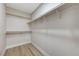 Walk-in closet with hardwood floors, ample shelving and hanging space at 1106 Emerald Stone Ave, North Las Vegas, NV 89081