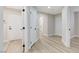 Hallway with wood-look flooring and white doors with black hardware at 1106 Emerald Stone Ave, North Las Vegas, NV 89081