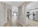 Hallway featuring archway to kitchen with stainless appliances and view to living area at 1106 Emerald Stone Ave, North Las Vegas, NV 89081