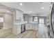 Bright and open kitchen with stainless appliances, modern white cabinets, quartz countertops, and wood-look flooring at 1106 Emerald Stone Ave, North Las Vegas, NV 89081