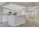 Modern kitchen with white cabinetry, stainless steel appliances, and breakfast bar at 1106 Emerald Stone Ave, North Las Vegas, NV 89081