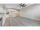 Open-concept living space with wood-look flooring, fireplace, and kitchen view at 1106 Emerald Stone Ave, North Las Vegas, NV 89081