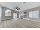 Open living room with a fireplace, large windows, and wood-look flooring at 1106 Emerald Stone Ave, North Las Vegas, NV 89081