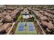 Aerial view of community with pool, tennis courts, and numerous homes at 11262 Corsica Mist Ave, Las Vegas, NV 89135