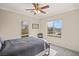 Cozy bedroom with a ceiling fan and large windows offering natural light at 11262 Corsica Mist Ave, Las Vegas, NV 89135