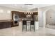 Modern kitchen with island, stainless steel appliances, and dark cabinets at 11262 Corsica Mist Ave, Las Vegas, NV 89135