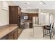 Modern kitchen with island, stainless steel appliances, and dark cabinets at 11262 Corsica Mist Ave, Las Vegas, NV 89135