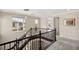 Elegant upper hallway with hardwood railing and modern lighting fixtures at 11262 Corsica Mist Ave, Las Vegas, NV 89135