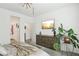 Bright bedroom featuring a ceiling fan, TV, monstera plant, and stylish decor at 1209 Crystal Grotto Ave, North Las Vegas, NV 89081