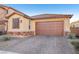 Exterior shot of home with brick driveway and desert landscaping in front at 1209 Crystal Grotto Ave, North Las Vegas, NV 89081