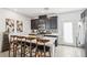 Modern kitchen with dark cabinets, stainless steel appliances, and a breakfast bar at 1209 Crystal Grotto Ave, North Las Vegas, NV 89081