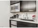 Compact kitchenette featuring modern appliances, ample storage, and stylish countertop decor at 1209 Crystal Grotto Ave, North Las Vegas, NV 89081