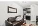 Inviting living room featuring a cozy couch, stylish mirror, and mini kitchenette at 1209 Crystal Grotto Ave, North Las Vegas, NV 89081