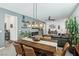 Open-concept living area featuring a dining table, modern lighting, and stylish decor at 1209 Crystal Grotto Ave, North Las Vegas, NV 89081