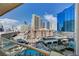 Expansive Las Vegas view from balcony overlooking pool and cityscape with blue skies at 135 E Harmon Ave # 817, Las Vegas, NV 89109