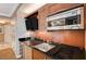 A well-equipped kitchenette features wooden cabinets and a sleek countertop at 135 E Harmon Ave # 817, Las Vegas, NV 89109