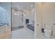 Modern bathroom featuring a sleek glass-enclosed shower, a freestanding tub and white marble-style tile flooring at 1691 Blackhorn St, Pahrump, NV 89048