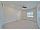 Bright and airy bedroom with a view of the fence, featuring neutral-colored walls, soft carpet, and recessed lighting at 1691 Blackhorn St, Pahrump, NV 89048