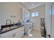 Bright laundry room with modern washer and dryer, ample storage and black countertops at 1691 Blackhorn St, Pahrump, NV 89048