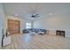 Spacious living room with wood-look flooring and a designer ceiling fan at 1691 Blackhorn St, Pahrump, NV 89048