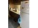 Compact kitchen featuring light countertops, dark cabinetry, and a white refrigerator at 1836 Mcdaniel St, North Las Vegas, NV 89030