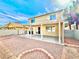 View of the home's backyard showing gravel landscaping, covered patio, and two-story home at 1838 Fighting Falcon Ln, North Las Vegas, NV 89031