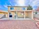 View of the home's backyard showing gravel landscaping, covered patio, and two-story home at 1838 Fighting Falcon Ln, North Las Vegas, NV 89031