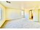 Bright bedroom with neutral carpet, white walls, and a large window for natural light to create a warm atmosphere at 1838 Fighting Falcon Ln, North Las Vegas, NV 89031