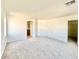 Bright, carpeted bedroom with neutral walls, a large window, and access to closet and bathroom for convenience at 1838 Fighting Falcon Ln, North Las Vegas, NV 89031