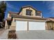 Inviting two-story home boasts a well-maintained exterior and attached two-car garage at 1838 Fighting Falcon Ln, North Las Vegas, NV 89031