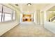 Spacious living area with a view of the kitchen, staircase, and a large window at 1838 Fighting Falcon Ln, North Las Vegas, NV 89031