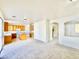 Bright living room showcasing carpet floors and an open concept connecting to the kitchen at 1838 Fighting Falcon Ln, North Las Vegas, NV 89031