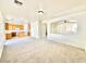 Spacious living room featuring carpet floors and an open layout to the kitchen at 1838 Fighting Falcon Ln, North Las Vegas, NV 89031