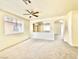 Bright, airy living room with a ceiling fan, neutral carpet, and an open layout at 1838 Fighting Falcon Ln, North Las Vegas, NV 89031