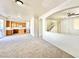 Open-concept living space that connects to the kitchen and staircase with neutral carpet at 1838 Fighting Falcon Ln, North Las Vegas, NV 89031