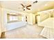 Spacious living area featuring a staircase, neutral carpet, and a seamless transition to other spaces at 1838 Fighting Falcon Ln, North Las Vegas, NV 89031