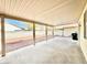 Covered patio with a concrete floor surrounded by gravel landscaping at 1838 Fighting Falcon Ln, North Las Vegas, NV 89031